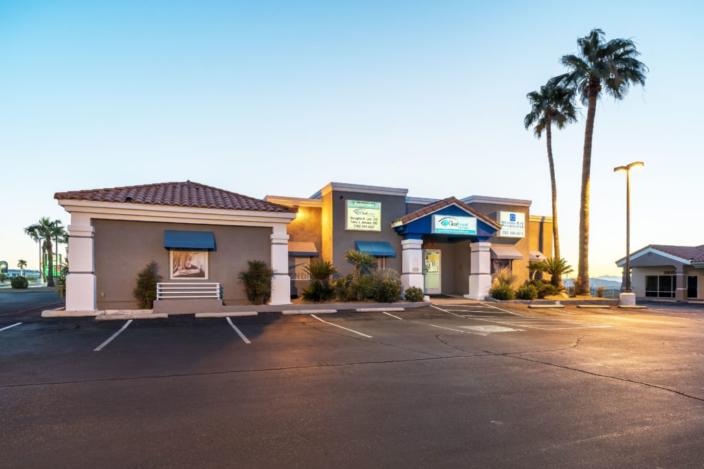 Exterior photograph of the ClearVision optometry practice with palm tree